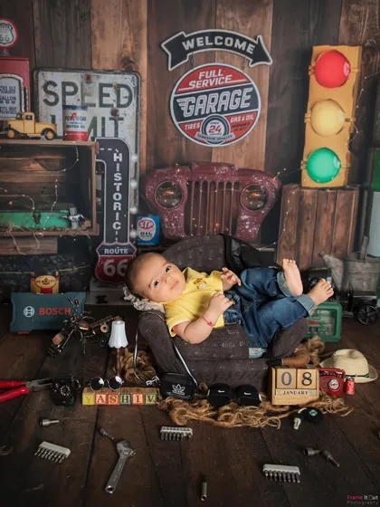 Wide awake and ready for work! Even when babies are awake, I can capture wonderful moments within my themed setups, like this little mechanic looking right at the camera.