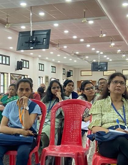 A wide shot of the audience at the Kanyakumari conference, showing the large and diverse gathering of yoga enthusiasts.