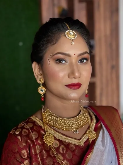 A front-facing view of this traditional look. The skin looks flawless, and the red lip adds a classic touch.