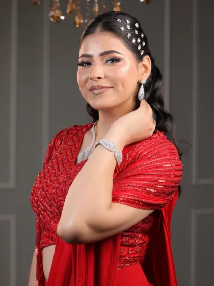A close-up of the red saree look, showcasing her radiant smile and the beautiful makeup that enhances her features.