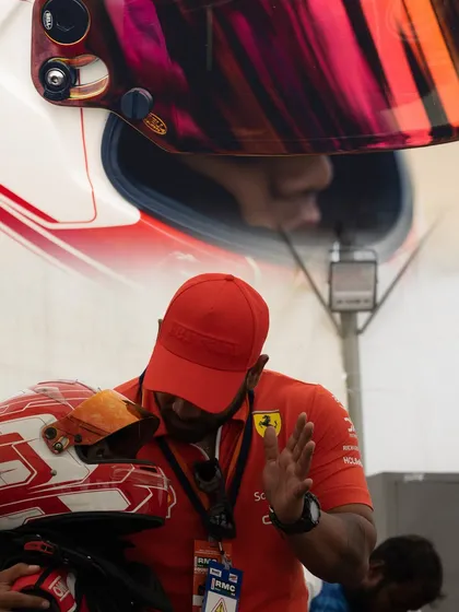 A close-up of a team member's hands, showing the focus and care that goes into preparing the karts.