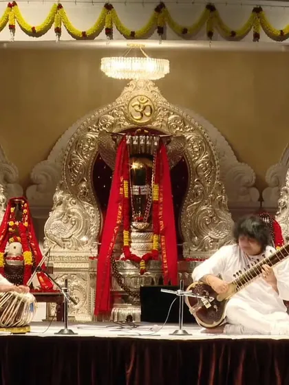 In the divine presence of Lord Shiva's idol while accompanying Pandit Niladri Kumar ji. The spiritual ambiance of the venue added a deep layer of devotion to the music.