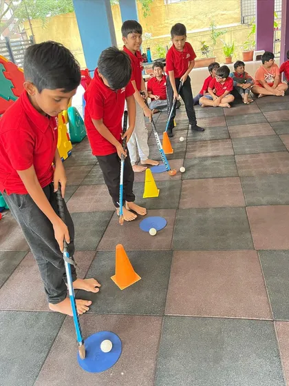 We introduce kids to the basics of different sports, like this playful hockey session. Our goal is to build fundamental skills like hand-eye coordination in a fun, no-pressure setting.