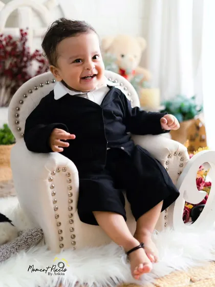 A close-up of pure happiness. This little boy's bright, happy smile is the star of his first birthday photoshoot.