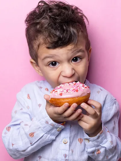 Just look at that bite. My fluffy, eggless donuts are a huge hit with the little ones, especially when they get to decorate them with pink frosting and sprinkles.