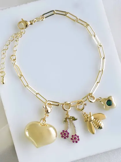 A sweet and simple charm bracelet with a heart, cherries, and a bee. It's the little things that make a piece special.
