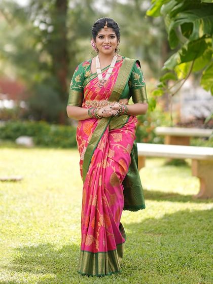 A full-length view of Devika's saree, showing how silk sarees never go out of style. This one is pure magic.