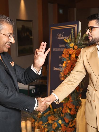 A warm welcome for a distinguished guest at our exclusive event celebrating the Zegna Trofeo Collection. His impeccable double-breasted suit is a testament to timeless style.