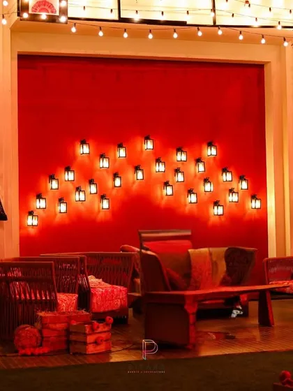We designed this lounge area for "Call Me Bae" with a cozy yet stylish feel. A bold red wall with an installation of flickering lanterns served as the backdrop for rustic wicker and wood furniture, creating a perfect spot for on-screen conversations.