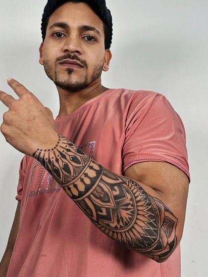 A client showing off his new full forearm sleeve of mandala and geometric patterns. The design flows perfectly from the wrist to the elbow.
