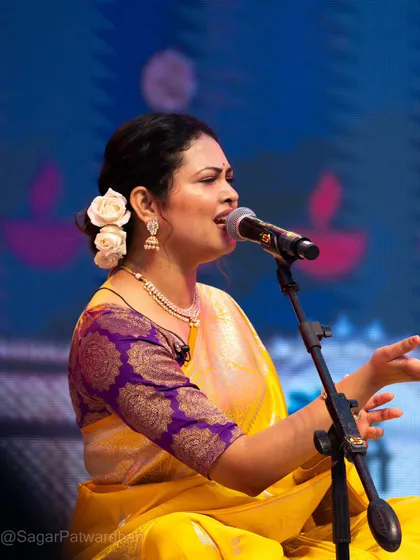 A side profile showing the beautiful hairstyle and the texture of the Banarasi blouse.