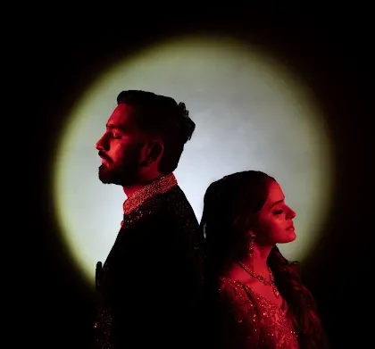 I love playing with dramatic lighting to create a cinematic feel. Here, a single spotlight isolates Pooja and Smit, creating a powerful and intimate portrait that feels like a still from a classic romantic film.