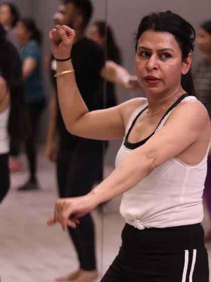 A member confidently performing a Bhangra step. Our classes help build not just fitness, but also confidence and grace.