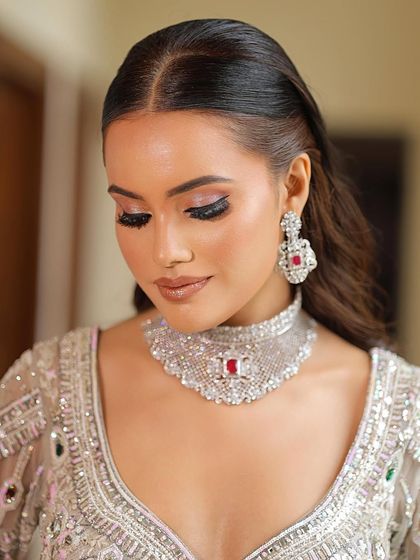 A close-up of the modern glam look. The focus is on the flawless skin and the beautifully blended pink and brown eyeshadow, perfect for a sophisticated event.