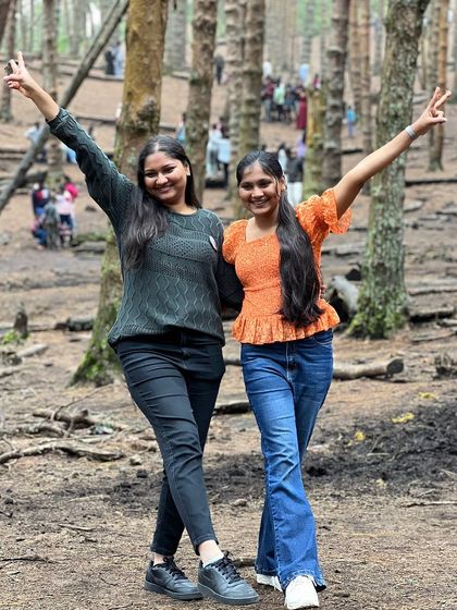 Two friends posing for a photo in the Kodaikanal pine forest.