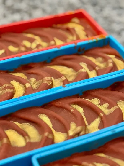 The tops of the custom Rainbow soap loaves before cutting. The swirls of gold on top add a touch of luxury.