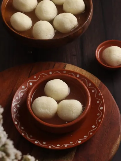 A shot of Rasgulla, a popular Indian sweet. The simple, clean styling puts the focus entirely on the dessert itself.