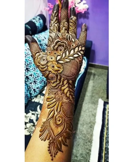 A unique design featuring a peacock feather motif, blended with floral and traditional patterns. This is a beautiful way to incorporate symbolic elements.