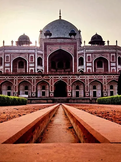 The grand facade of Humayun's Tomb, a UNESCO World Heritage site. The symmetry and scale of this red sandstone and marble structure represent a high point in Mughal architecture, a subject we delve into deeply during our walks through Delhi's imperial landscapes.
