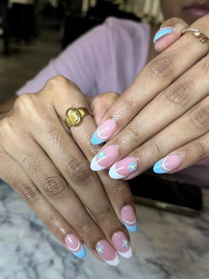 This angle shows the delicate, hand-painted daisies and the clean lines of the French and colored tips.