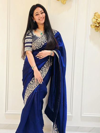 A full-length view of the guest in her royal blue saree. The outfit is a perfect example of how we create elegant and sophisticated looks for any occasion.