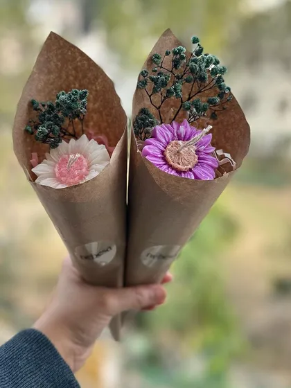 Here I am holding two of my mini candle bouquets. They are a wonderful alternative to real flowers because they last forever and can be lit to release a beautiful fragrance. I offer them in various flower shapes and colors.
