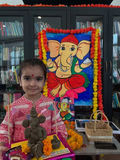 A sweet smile and a beautiful handmade Ganesha idol. Our workshops are designed to be fun and accessible for all age groups.