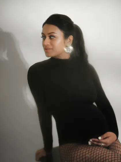 A soft, elegant portrait demonstrating how to pose a client sitting down while maintaining a flattering and graceful silhouette.