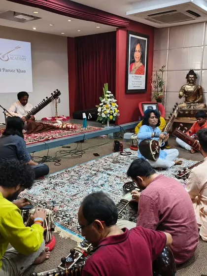 Students listening intently as Ustadji shares his knowledge. These workshops are not just about technique; they are about absorbing the philosophy and wisdom of a great artist.