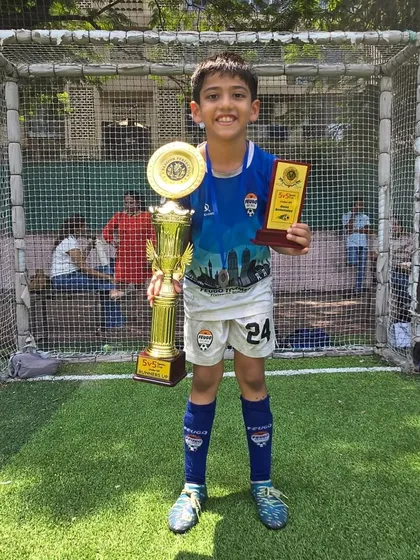 Zarrar Lakha from our U-9 team proudly holds his championship trophy.
