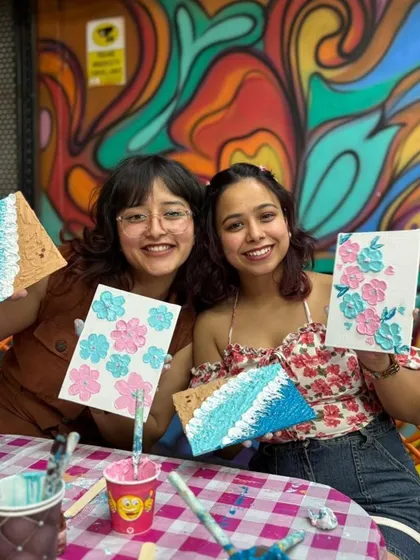 Look at those smiles! Two friends showing off the textured art they created. Our painting workshops are a space to experiment with color and texture, and you always leave with a unique piece of art for your home.