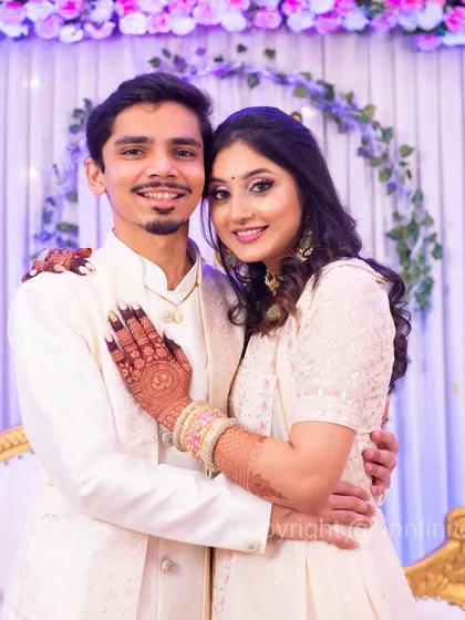 A classic posed portrait of the couple in elegant white outfits against a beautifully decorated backdrop. I provide direction to ensure you both look your best in these formal shots.