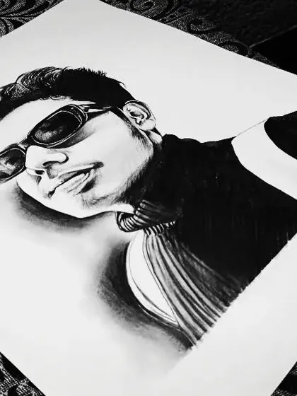 A self-portrait sketch in black and white. I experimented with a low angle and strong shadows to create a dramatic effect.