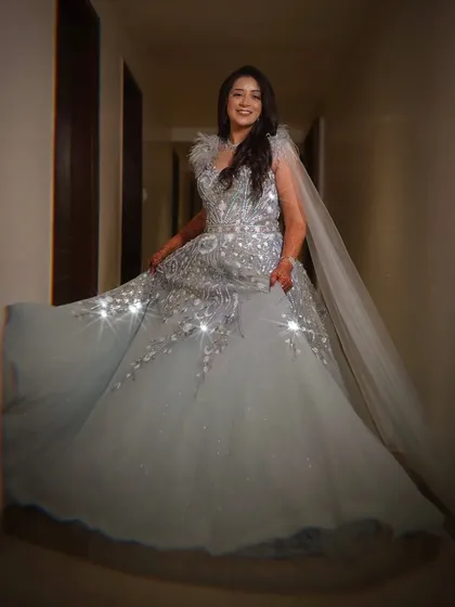 The bride twirls in her sparkling silver gown, the light catching the embellishments perfectly. I love capturing these dynamic shots that show off the beauty and movement of the reception outfit.