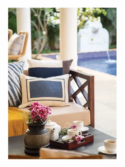 Sun, sand, beach, and pools. This close-up captures the essence of our Goa holiday home projects. A comfortable outdoor sofa by the pool is the perfect place to enjoy a cup of tea and soak in the tropical atmosphere.