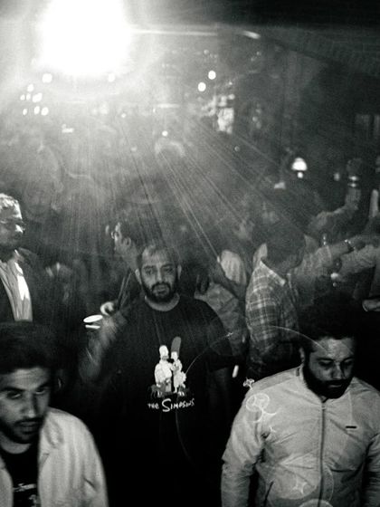 A black and white shot of the crowd, capturing the raw, underground feel of the night. It's all about the music and the people.