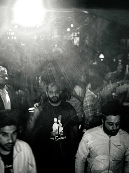A black and white shot of the crowd, capturing the raw, underground feel of the night. It's all about the music and the people.