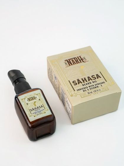 A product and packaging shot for a men's beard oil. Showing the box alongside the bottle is crucial for e-commerce as it displays the full retail product.