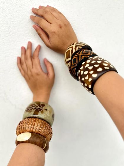 This shot shows how the two different stacks can still look cohesive because they share a similar color palette of browns and creams. This is a key principle of accessory styling.