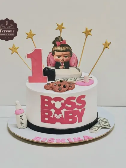 A "Boss Baby" theme cake for a little one turning one. This mango-flavoured cake features the girl version of Boss Baby, complete with fondant money, cookies, and a baby bottle.