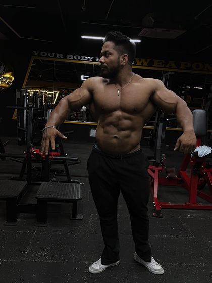 Use pain as fuel. A classic physique pose showing the V-taper.