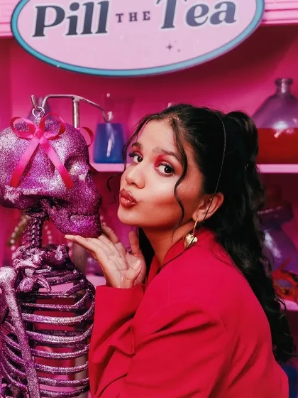 Another playful shot of Srishti Garg from the "Pookie Clinic" shoot. The makeup is bold and colorful, designed to be eye-catching and fit the unique aesthetic of her YouTube channel.