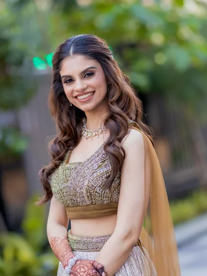 A bright and happy portrait of this engagement bride. Her makeup is fresh and glowing, with soft curls framing her face, creating a look that is effortlessly beautiful.