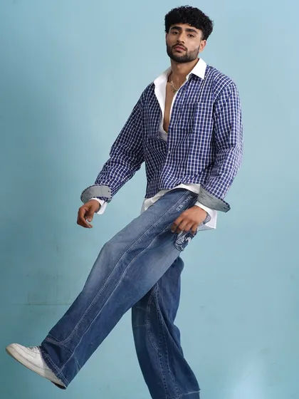 A full-length shot showing the relaxed, modern vibe. The hair is styled to look effortlessly cool, complementing the layered, casual outfit.
