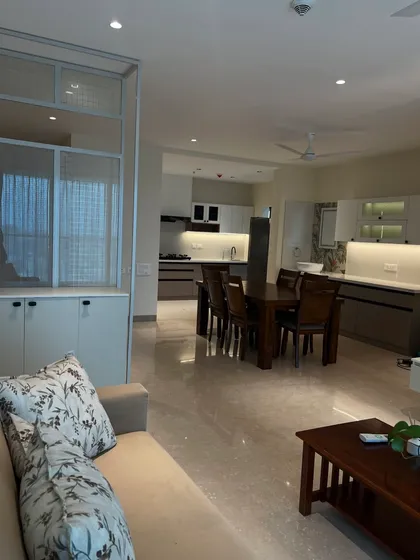 An open-plan living and dining area designed for seamless flow. The neutral color palette and clean lines create a spacious and calming environment.