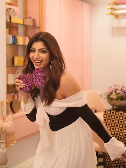 A happy and bright shot of Akanksha Puri. Her makeup is fresh and glowing, with a focus on radiant skin and a sparkling smile.