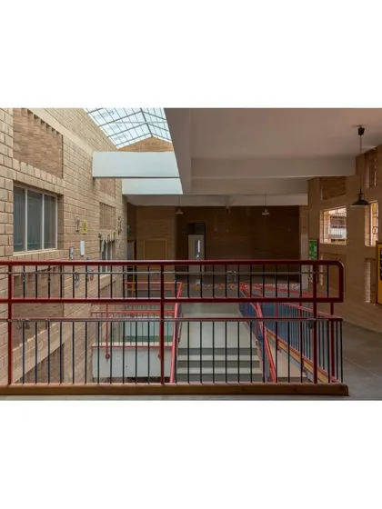Looking down into the central circulation spine of Buddhi School, lit from above by a long skylight. This design ensures that even the core of the building is filled with natural light.