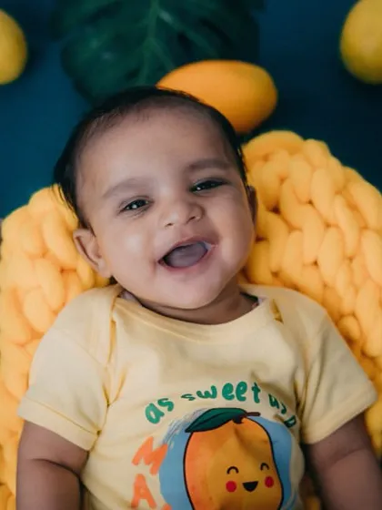 This happy mango baby is all smiles. Capturing these joyful moments is the best part of my job as a baby photographer.