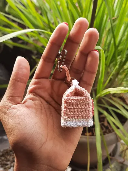 The back of the strawberry milk keychain, showing the clean construction and the small loop for the hardware.