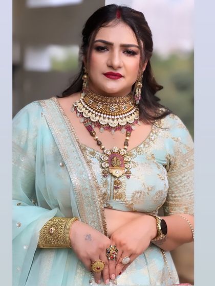 A beautiful makeup look for a party. The client looks stunning in a light blue lehenga with bold red lips.